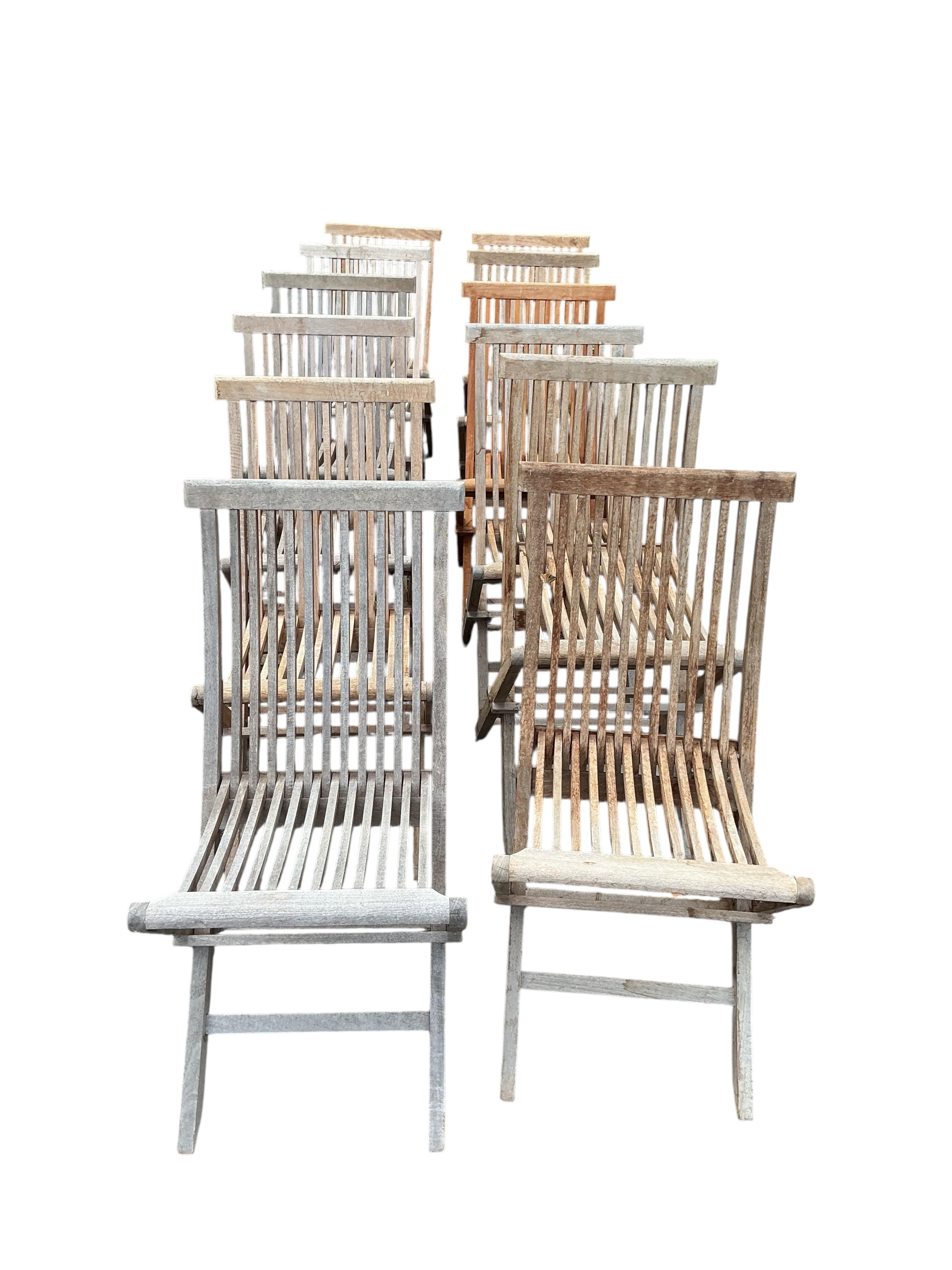 Twelve teak folding garden chairs